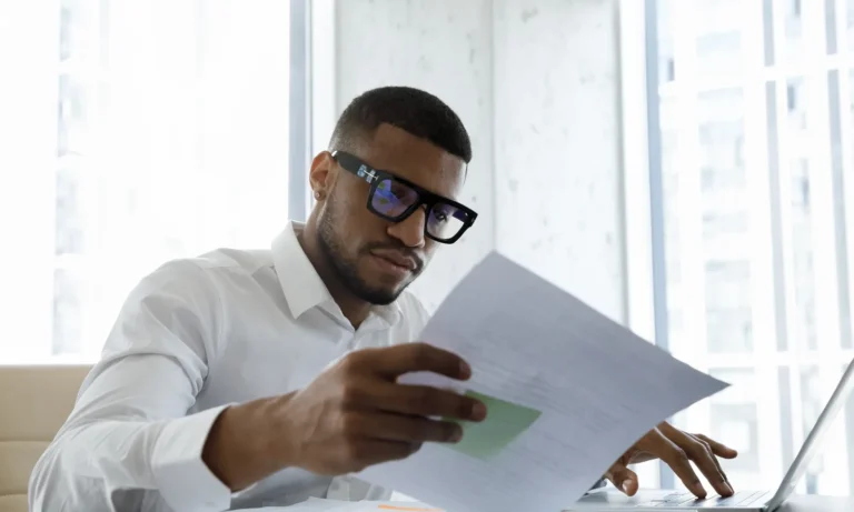 Director reviewing financial reports to identify early signs of business distress