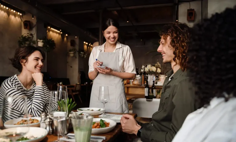 Hospitality venue kitchen staff during service, representing cash flow pressure from Payday Super changes